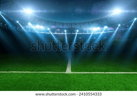 Modern football stadium with green lawn and blue spotlight. Soccer background. Football champions Royalty-Free Stock Photo #2410554333