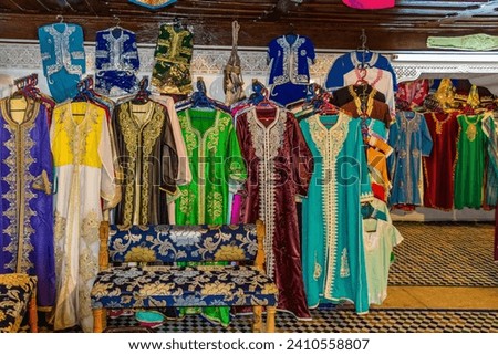 Morocco, row of typical colourful womens embroidered djellaba tunics for sale Royalty-Free Stock Photo #2410558807