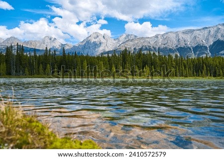 A beautiful clean, transparent mountain lake with a view of the rocky mountains in Kananaskis in the province of Alberta, Canada