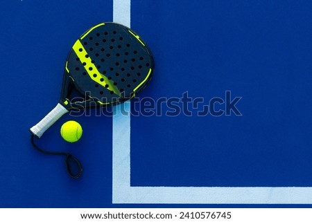 Padel tennis racket. Background with copy space. Sport court and balls. Royalty-Free Stock Photo #2410576745