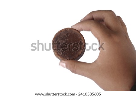 hand holding brown sugar isolated white background