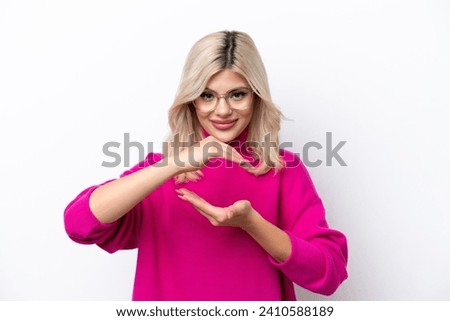 Young Russian woman isolated on white background holding copyspace imaginary on the palm to insert an ad