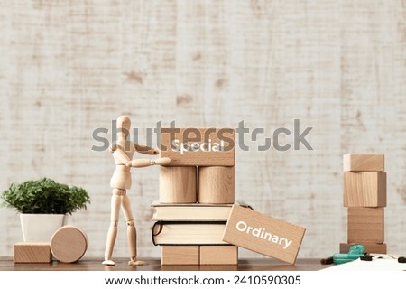 There is wood block with the word Special or Ordinary. It is as an eye-catching image. Royalty-Free Stock Photo #2410590305