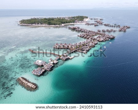 Drone view of Mabul Island, the base for diving in Sipadan Island, Sabah state in Malaysia. Royalty-Free Stock Photo #2410593113