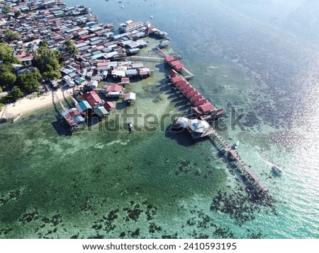 Drone view of Mabul Island, the base for diving in Sipadan Island, Sabah state in Malaysia. Royalty-Free Stock Photo #2410593195