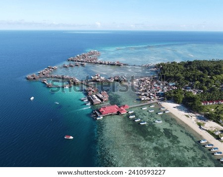 Drone view of Mabul Island, the base for diving in Sipadan Island, Sabah state in Malaysia. Royalty-Free Stock Photo #2410593227