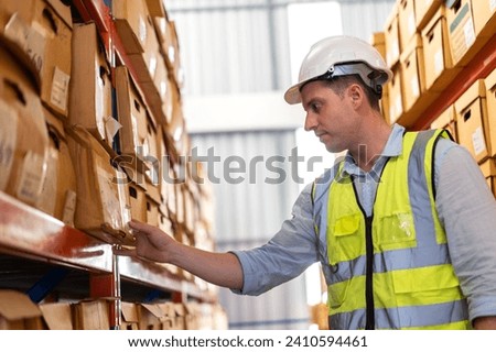 Portrait engineer man shipping order detail check goods and supplies on shelves with goods background inventory in factory warehouse.logistic industry and business export	