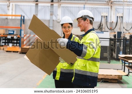 paper cardboard manufacture factory concept, industry worker person working with machine to recycling material package box in warehouse storage or plant production for global logistic business