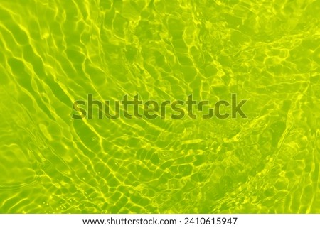  Green water waves on the surface ripple blurred. Defocus blurred transparent blue colored clear calm water surface texture with splash and bubbles. Water waves with shining pattern texture background