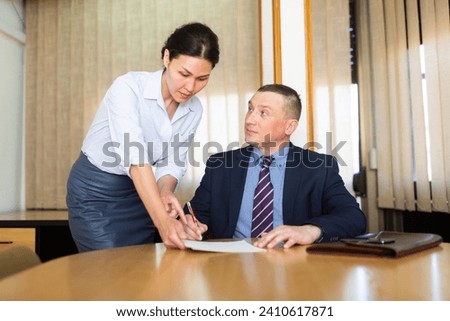 Adult male interview candidate signing apply for job at meeting room in office