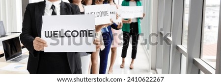 Group of unrecognizable people joins together greeting and hold welcome words for a sign of happiness and pleasure for coming of something or someone.