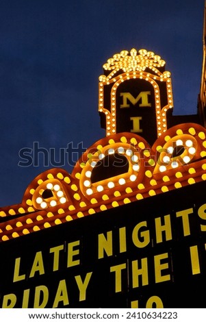 Vintage Theater Marquee Sign at Night with Bright Bulbs and Event Text