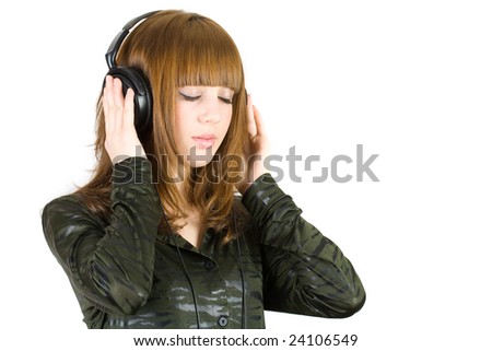 Close-up portrait of a girl listening music at headphones