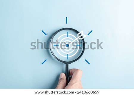 Magnifier glass focus to target objective with idea creative light bulb icon. planning development leadership and customer target group concept. Royalty-Free Stock Photo #2410660659