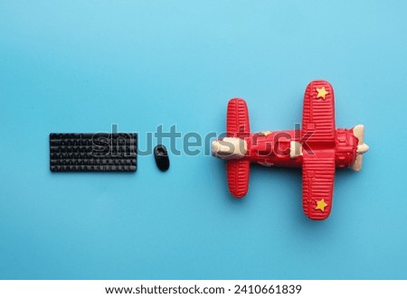 A picture of keyboard, mouse and aircraft miniature on blue background. Search the flight concept.