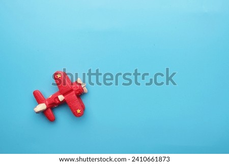 A flatlay picture of classic aircraft on blue background. Travel and adventure concept.