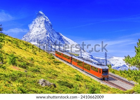 Zermatt is a car-free town located in the Swiss Alps. The town is known for its stunning views of the Matterhorn, one of the most iconic mountains in the world. Zermatt is also a popular destination  Royalty-Free Stock Photo #2410662009