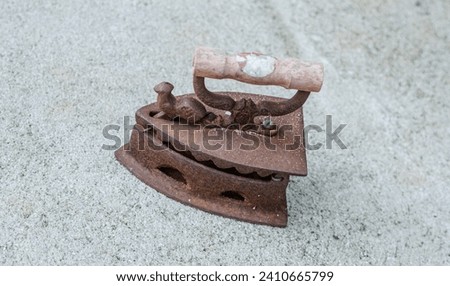 Ancient irons were made of iron with space in the middle for charcoal as a heater. Royalty-Free Stock Photo #2410665799