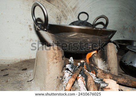 Traditional way of making food on open fire in old Indian kitchen in a village