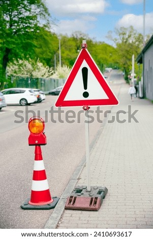 Traffic code with traffic sign danger point on a road, red exclamation attention sign, danger red triangle road sign 