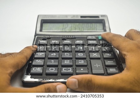 hand calculating using a calculator isolated on white background. perfect for Education, mathematics, and Business Article or Content.
