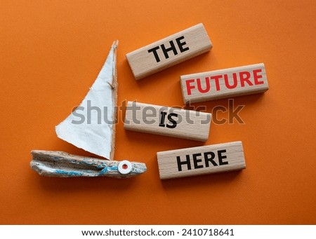 The future is here symbol. Concept words The future is here on wooden blocks. Beautiful orange background with boat. Business and The future is here concept. Copy space.