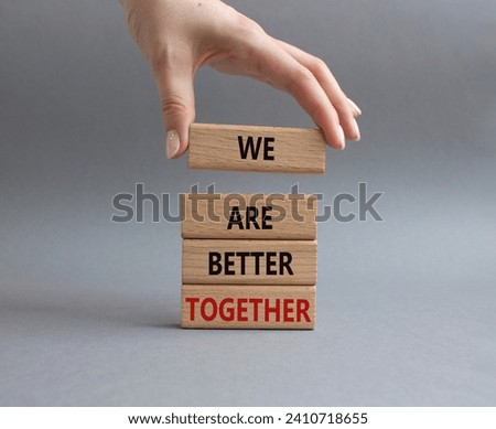 We are better together symbol. Wooden blocks with words We are better together. Beautiful grey background. Businessman hand. We are better together concept. Copy space. Royalty-Free Stock Photo #2410718655