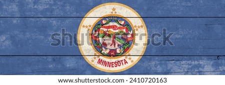 Minnesota State flag on a wooden surface. Banner of the grunge Minnesota State flag. 