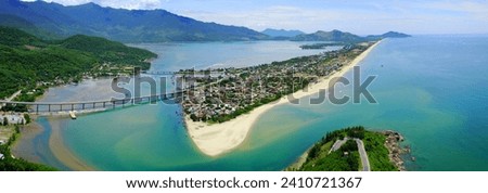 Panoramic view of Lang Co, Hue, Vietnam. Beautiful landscape of Lang Co Bay with sandy beach, mountain, and bridge. Royalty-Free Stock Photo #2410721367