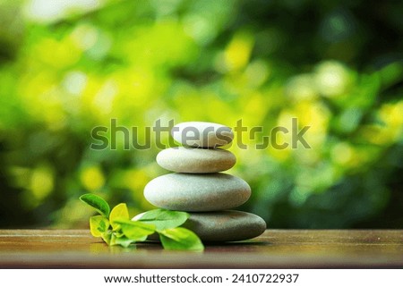balancing pile of pebble stones, like ZEN stone, outdoor in springtime, spa wellness tranquil scene concept, soul equanimity mental calmness picture