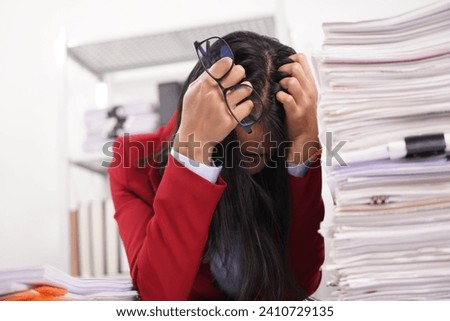 Asian and African office workers trying to feel bored, unhappy and bored working in the office. Business woman. Office worker working with pile of A4 papers. Happy working. Working.