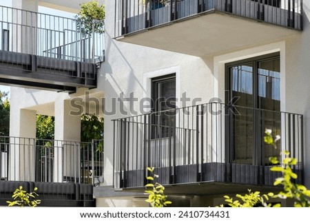 Modern Facade Building with Modern Balcony of Multifamily Low rise Apartment Building and Bridge between Houses. Residential Building Exterior Design of Modern Homes and Town houses. Royalty-Free Stock Photo #2410734431