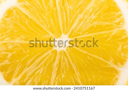 Lemon slice close-up, yellow fruit abstract background. Royalty-Free Stock Photo #2410751167