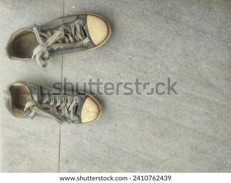 taking picture of dirty shoes on floor
