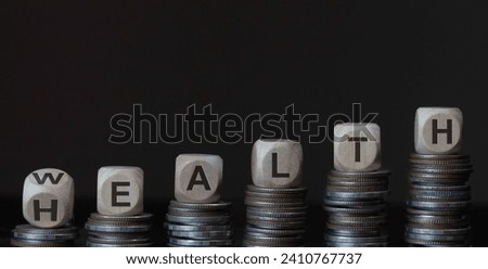 Wooden cube with word wealth to health with coins stack step up growing growth value on dral background. Investment in life insurance and healthcare concept.