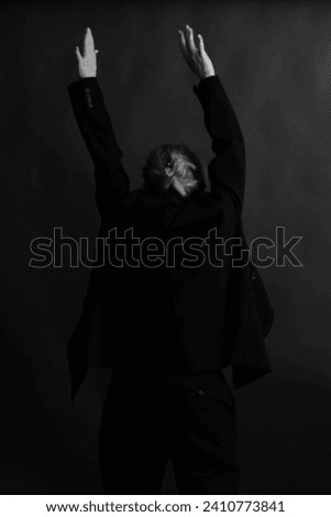 Refined and elegant hands of a dancer, dancing with body parts, black and white portrait of the performer's hands on a dark background Royalty-Free Stock Photo #2410773841
