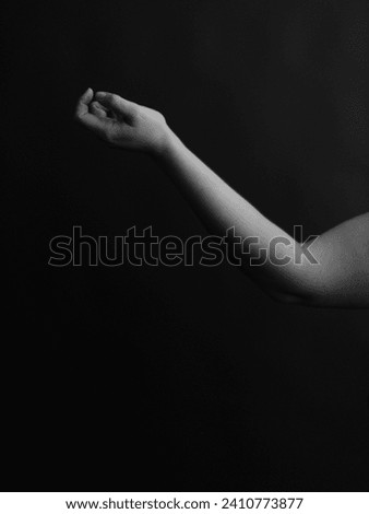 Refined and elegant hands of a dancer, dancing with body parts, black and white portrait of the performer's hands on a dark background Royalty-Free Stock Photo #2410773877