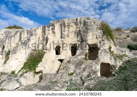 Necropolis of Tuvixeddu Park, the largest Punic necropolis still in existence. Carthaginian shaft tombs, used from the 6th to the 3rd century BC, then reused in Roman times. Cagliari, Sardinia, Italy Royalty-Free Stock Photo #2410780245