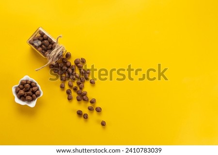 Hazelnut peeled on a yellow background.Top view.Copy space 