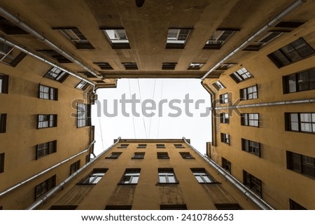 Courtyard well in old residential house in the historical center of Saint-Petersburg, Russia Royalty-Free Stock Photo #2410786653