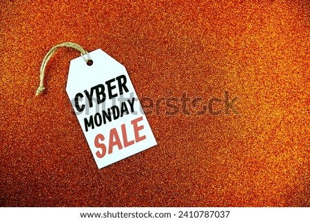 Cyber Monday Sale text on price tag top view on orange glitter background