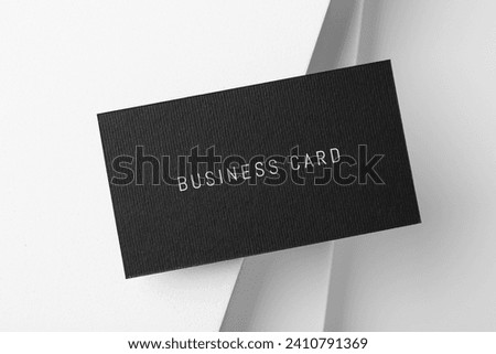 Black business card on white background, top view