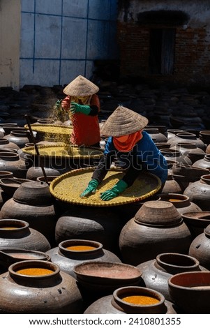 Homemade soy sauce facility in Vietnam. People are making Ban soya sauce at Ban Ward, Hung Yen province, Vietnam. Travel concept Royalty-Free Stock Photo #2410801355