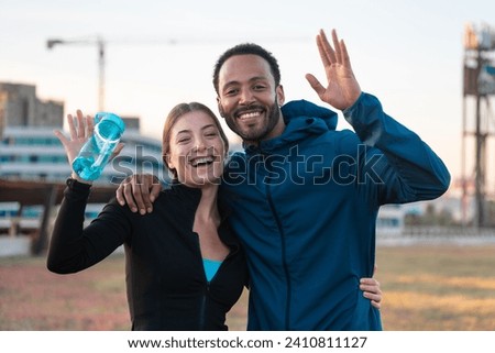 Portrait happy young couple ready to exercise outdoors.