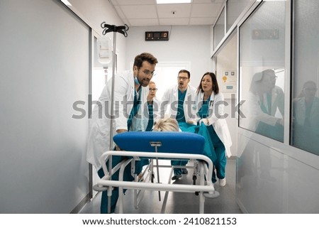 Nurses and doctors in a hurry taking patient to operation theatre. Patient on hospital bed pushed from surgeon and his team to emergency theatre. Team of doctors and surgeon rushing patient.