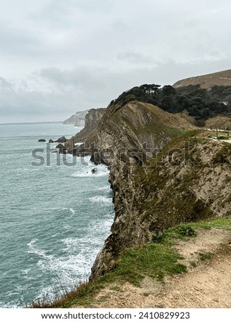 Jurassic coast view in Dorset at winter time. Cold winter day. Lulworth Cove cliffs view on a way to Durdle Door. The Jurassic Coast is a World Heritage Site on the English Channel coast of southern E