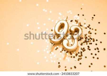 93 years celebration festive background made with golden candles in the form of number Ninety-third lying on sparkles. Universal holiday banner with copy space. Royalty-Free Stock Photo #2410833207
