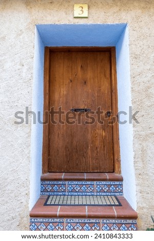 old wooden mini-door, located in an old Spanish village