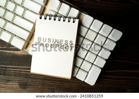 Closeup view of a notebook with Business Prospect text on a computer keyboard on a wooden background. Business management concept