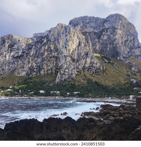 Rocky mountain and seashore. Sky with thunderclouds, mountain view, Capo Gallo nature reserve in Sicily, Sferracavallo. Landscape, natural beauty, hiking trail.